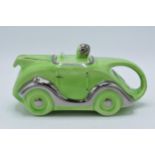 A 1930s Art Deco Sadler racing car teapot in lime green glaze with silvered detailing Reg No 820236,