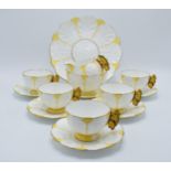 A collection of Aynsley yellow leaf moulded tea ware to include 5 tea cups with butterfly finial