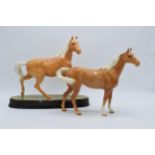 A pair of Beswick palomino horses to include Swishtail 1182 and a similar item on ceramic base (