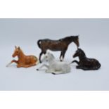 A collection of Beswick horses to include lying foals 915 in grey, brown and palomino colourway