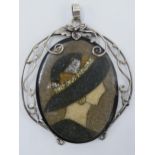 A silver mounted mosaic-style portrait pendant, 8.5cm tall. Minor damage to right hand side of