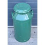 A vintage metal milk churn painted in green colours, 72cm tall.