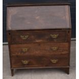 A 1930s brown oak student's bureau, 89x39x103cm tall. In good functional condition with age