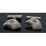 A pair of hallmarked silver cufflinks in the form of grouse heads set with blue sapphires for eyes