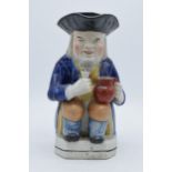 A late 18th / early 19th Century Staffordshire Toby jug with figural handle and black tricorn hat,