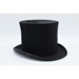 A Henry Heath Limited black top hat. There are no sizes on the interior however in the opening at