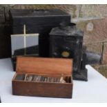 A cased Negretti and Zambra magic lantern in wooden box with a box of slides with examples such as