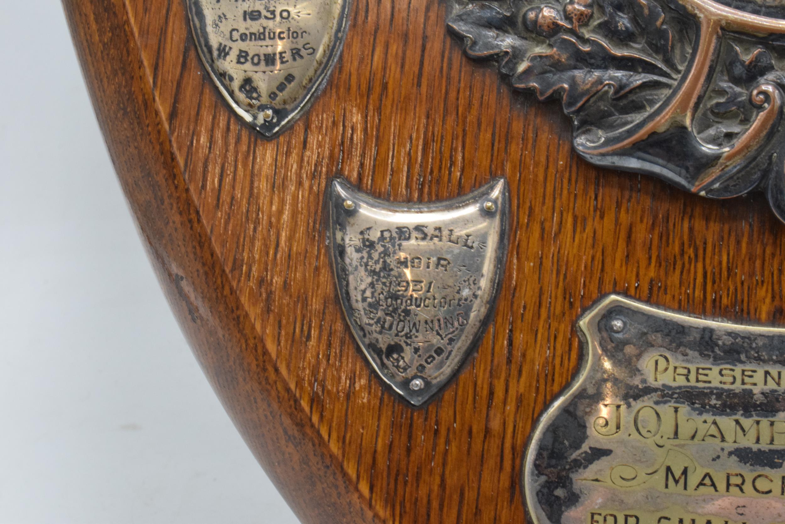 A wooden presentation shield with hallmarked silver name shields and a silver plate central relief - Image 4 of 12