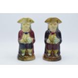 A pair of 19th century majolica glaze Toby jugs of gentleman in tricorn hats holding jugs, 20cm