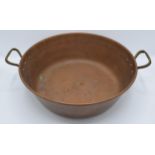 An early 20th century copper and brass pan, 47cm wide. In good condition with no obvious damage or