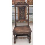 An early to mid 19th century Wainscot-style oak chair with carved back panel, 108cm tall. In good