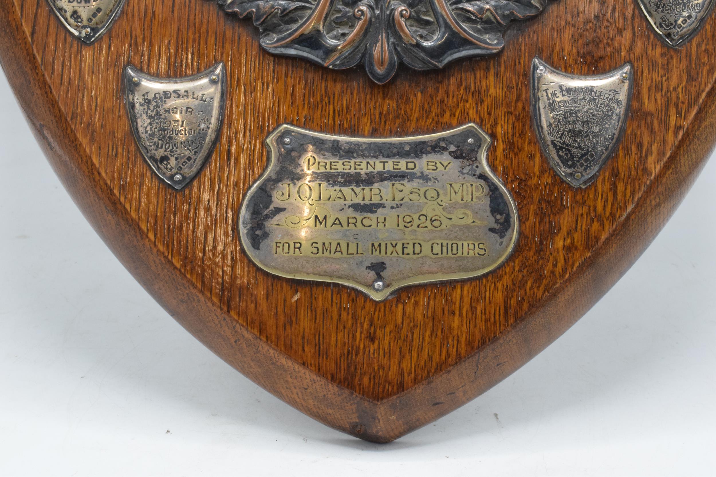 A wooden presentation shield with hallmarked silver name shields and a silver plate central relief - Image 3 of 12