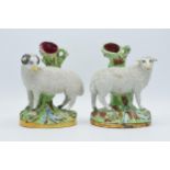 A pair of mid 20th century Staffordshire flatback spill vases with sheep decorated with granular