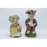 A pair of Shorter Toby jugs to include Flower Seller and a gentleman holding a jug (2). Tallest