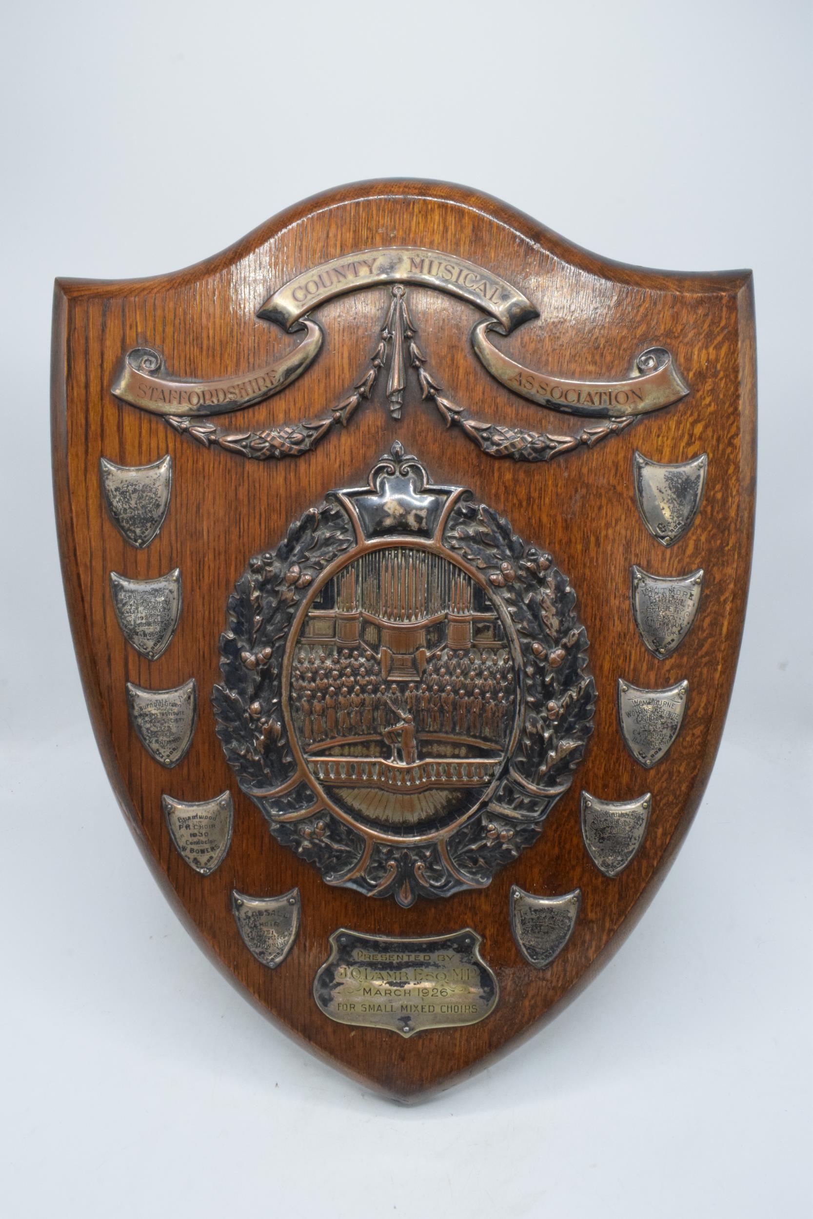 A wooden presentation shield with hallmarked silver name shields and a silver plate central relief - Image 2 of 12