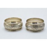 A pair of silver napkin rings with floral decoration, Chester 1923, 16.1 grams.