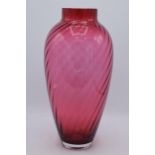 A large vintage cranberry glass with swirling decoration, 35cm tall. In good condition with no