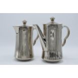 A pair of Royal Worcester silver pottery tea and coffee pots (2). In good condition with no