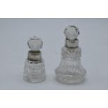 A pair of miniature silver-rimmed scent bottles, London 1884 and Birmingham 1903, 8cm tallest (2).