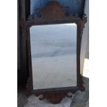 A late 19th century carved wooden wall-hanging mirror, 71cm tall.