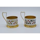 A pair of Soviet tea glass holders with enamel decoration (2). 9cm tall. In good condition with some