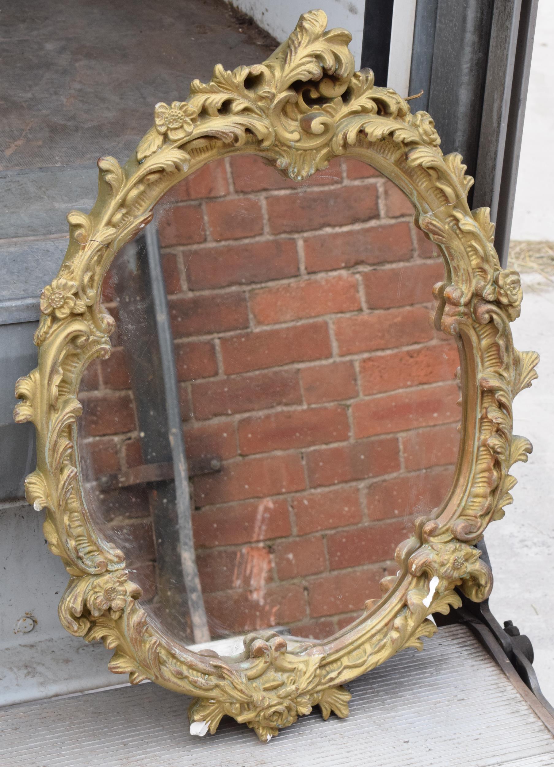 A mid 20th century gilt-style plaster mirror, 67cm tall. In good functional condition with some