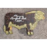 Wooden Hereford bull sign with 'Champion Hereford Bull 1889' painted.