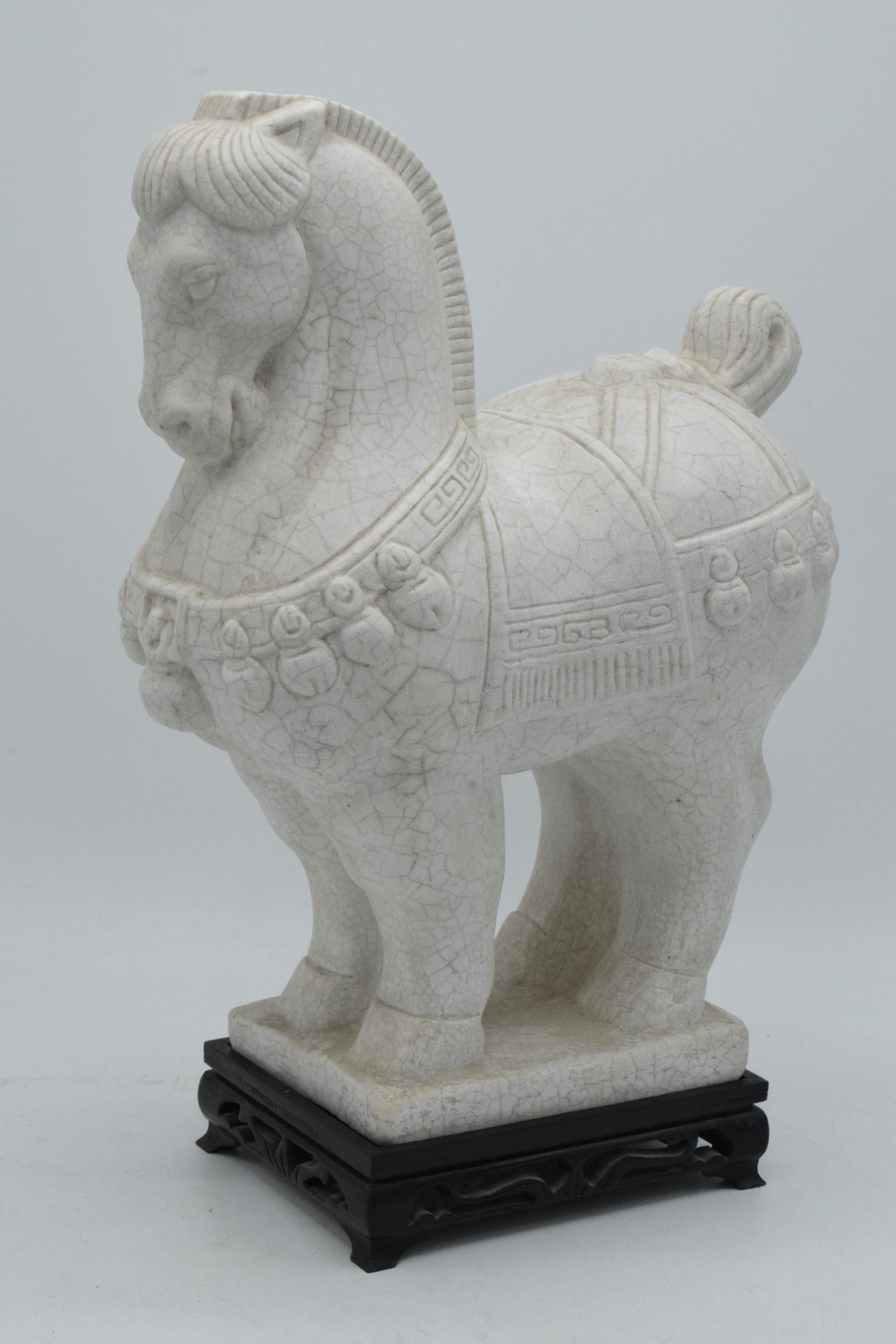 A mid to late 20th century marble-style figure in the manner of a Tang horse on a wooden base, 31.