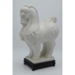 A mid to late 20th century marble-style figure in the manner of a Tang horse on a wooden base, 31.