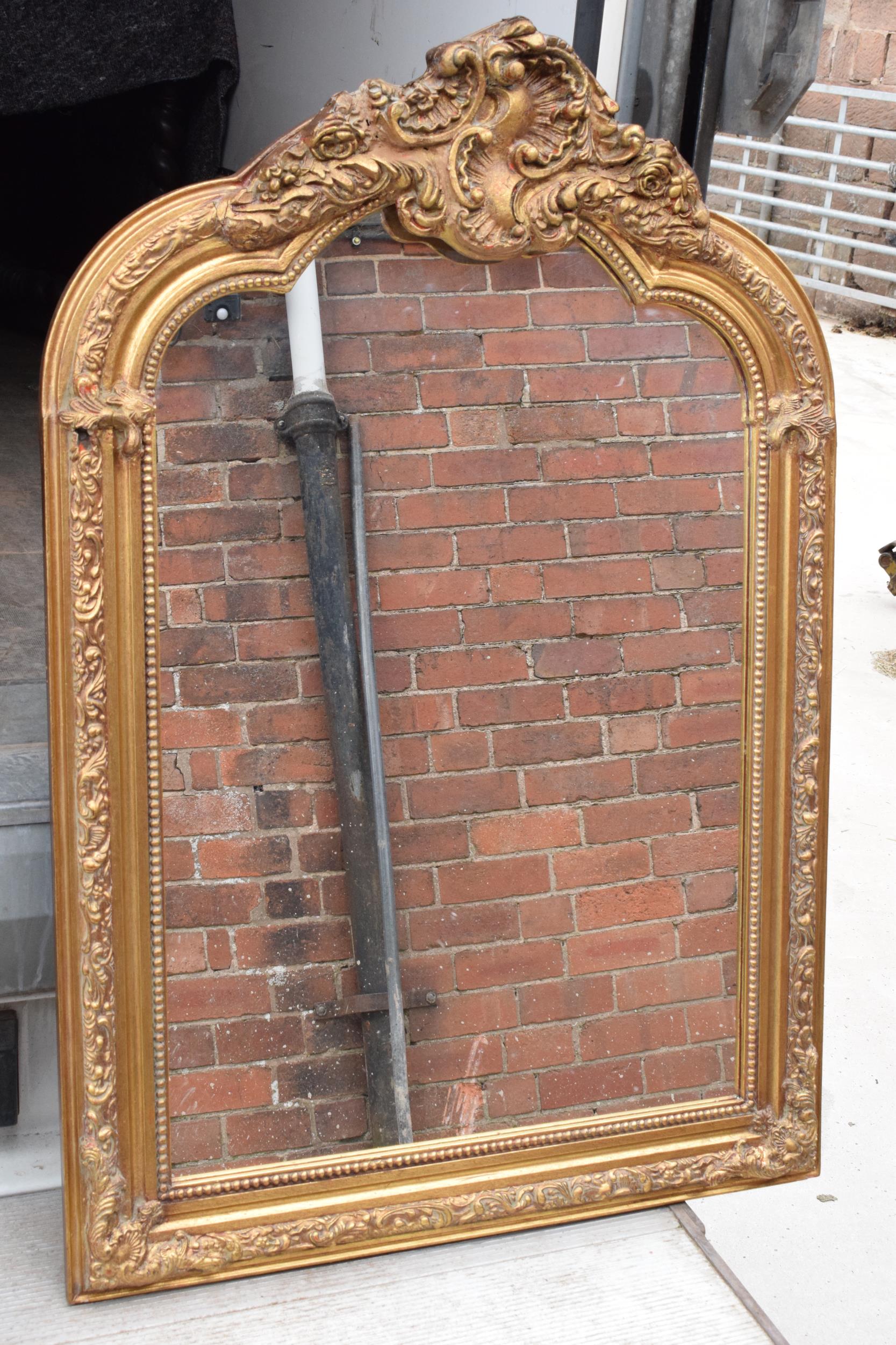 A large vintage gilt-style hanging over mantle mirror, 118cm tall. In good functional condition with