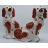 A pair of late 19th century Staffordshire dogs with red decoration (2). Some damages and wear to