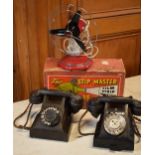 A pair of vintage Bakelite wired telephones together with The Stip Master projecter and a vintage