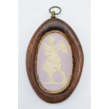 A 19th century lilac jasperware oval cameo of a cherub with domed shaped with gilt floral edge in