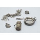 A collection of mostly hallmarked silver items to include a charm bracelet, pocket watch case, a