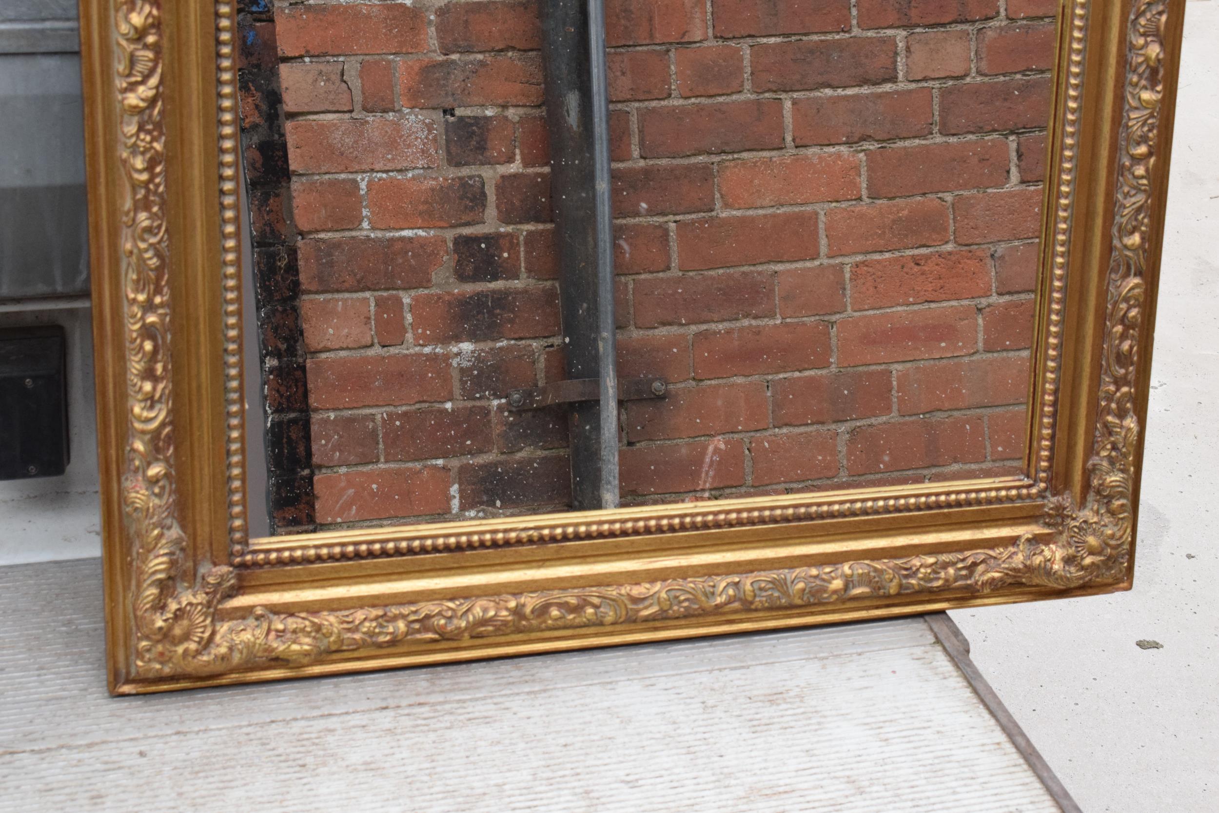 A large vintage gilt-style hanging over mantle mirror, 118cm tall. In good functional condition with - Image 4 of 7