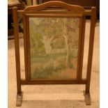 A 20th century wooden fire screen with tapestry decoration, 79cm tall. In fair condition showing