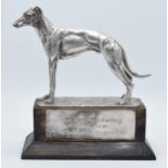 A silver plated model of a realistically modelled greyhound on wooden base with matching plaque '
