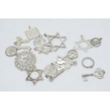 A collection of silver and white metal jewellery items to include pendants such as stars, keys