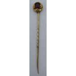 9ct gold (testing as 9ct gold or better) stick pin set with purple stone, 1.6 grams. 6cm long.