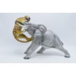 A large Italian ceramic figure of an elephant and tiger by Ronzan, 29cm tall. Generally, in good