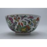 A late 19th / early 20th century Chinese bowl with animals amongst foliage with floral decoration to