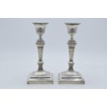A pair of Victorian silver candlesticks with loaded bases, hallmarks rubbed thought to be London