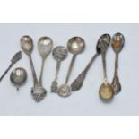 A collection of silver tea spoons of varying forms, 106.8 grams (various grades of silver). One