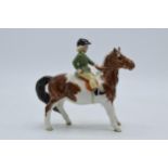 Beswick Girl on Pony 1499, with damages. Piece displays well from a distance though the girls head