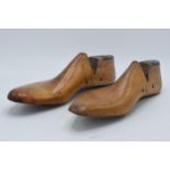 A pair of vintage wooden and metal cobblers shoe moulds (2). 30cm long.