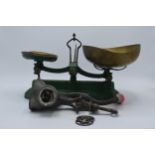 A set of painted green postage scales together with small brass weights and a food grinder (Qty).