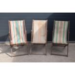 A trio of vintage 20th century wooden and fabric folding deck chairs (3). Age-related wear and use