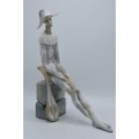 Lladro figure of a long-limbed harlequin seated with mandolin, 36cm tall. In good condition with