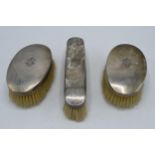 Three-piece silver brush set, all with matching engraved monogram, London 1907 (3). 18cm longest. In