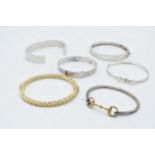A collection of silver 925 bangles to include a silver gilt example, a spanner example and others (